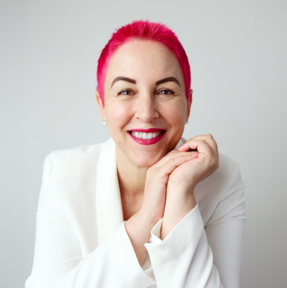 Image of Gabriela Humailo Parker - a confident lady with pink hair, a reassuring smile, and hands you can relax into